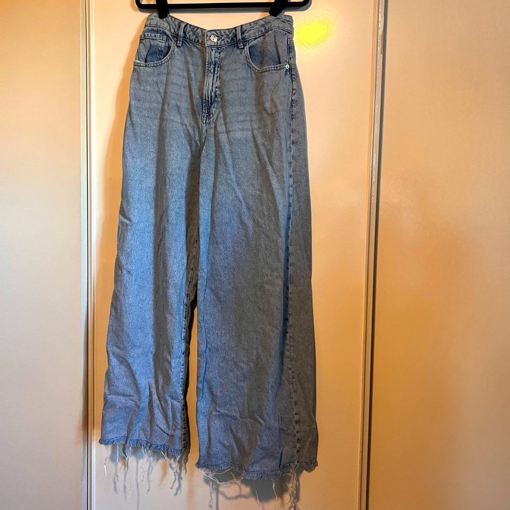 Forever 21 size 30 super wide leg denim blue jeans. Fringed bottom. High rise.
